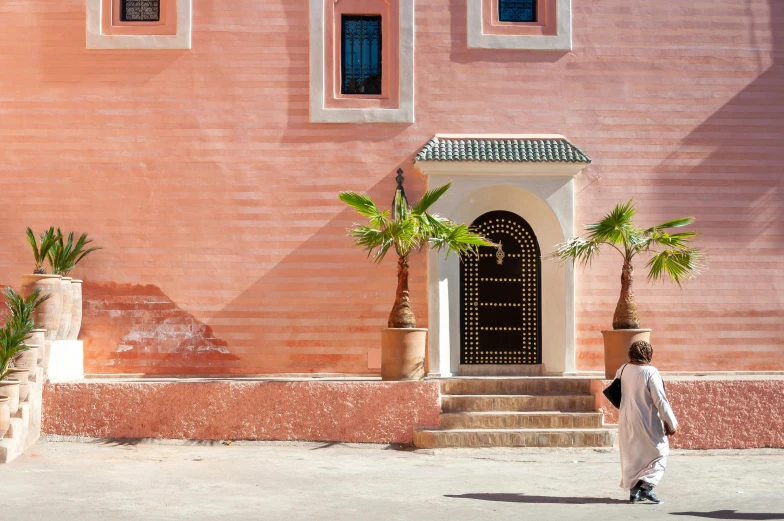 a man walking down the street in front of a building