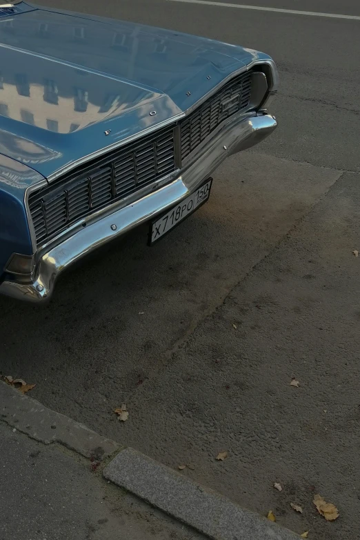 an old classic car sitting on the curb