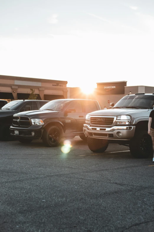 a line of pickup trucks parked next to each other