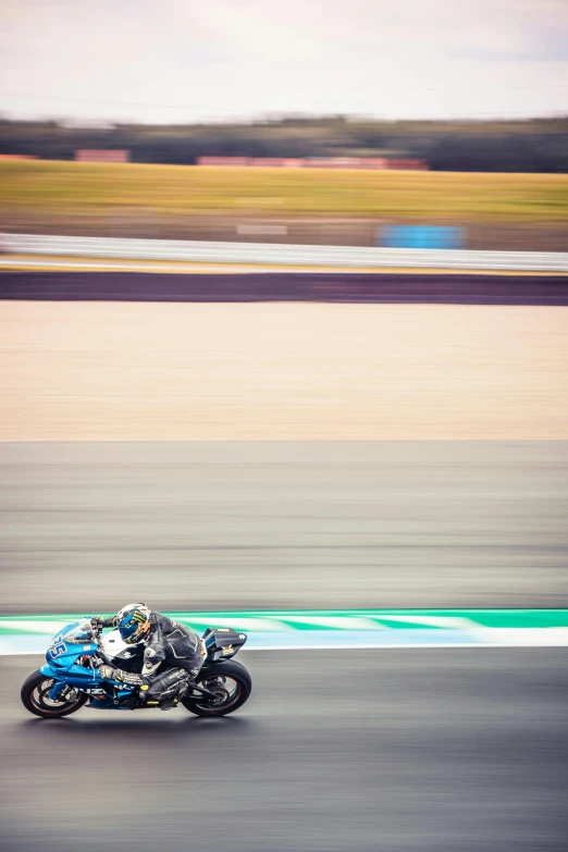 two people riding motorcycles with each other on the race track