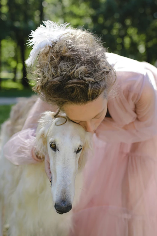 an older lady petting a large dog on the head