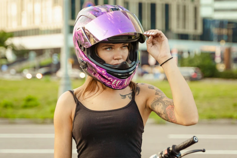 the woman wearing a helmet poses for a po