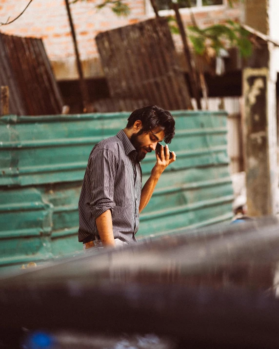 a man talks on his cellphone while standing outside