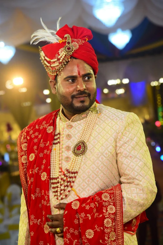 man in red and gold costume standing in front of a mirror