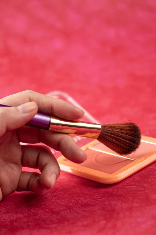 a close up of a person holding a small brush