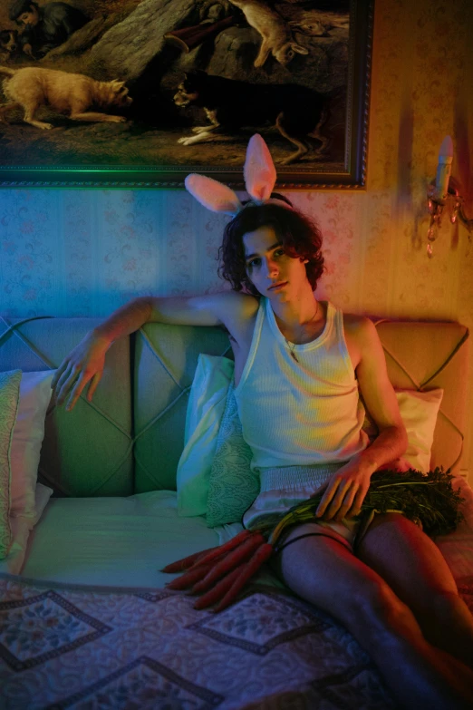 a woman dressed as bunny sitting on top of a bed