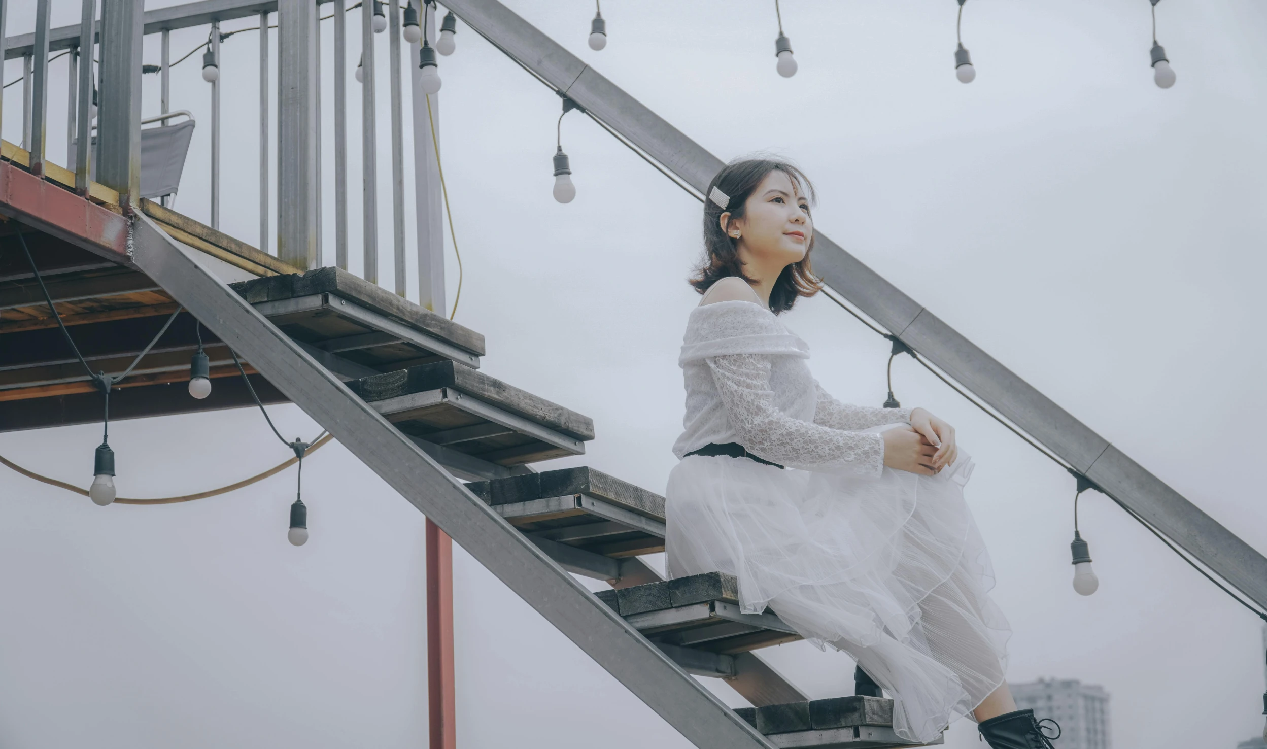 a young woman is standing on the stairs