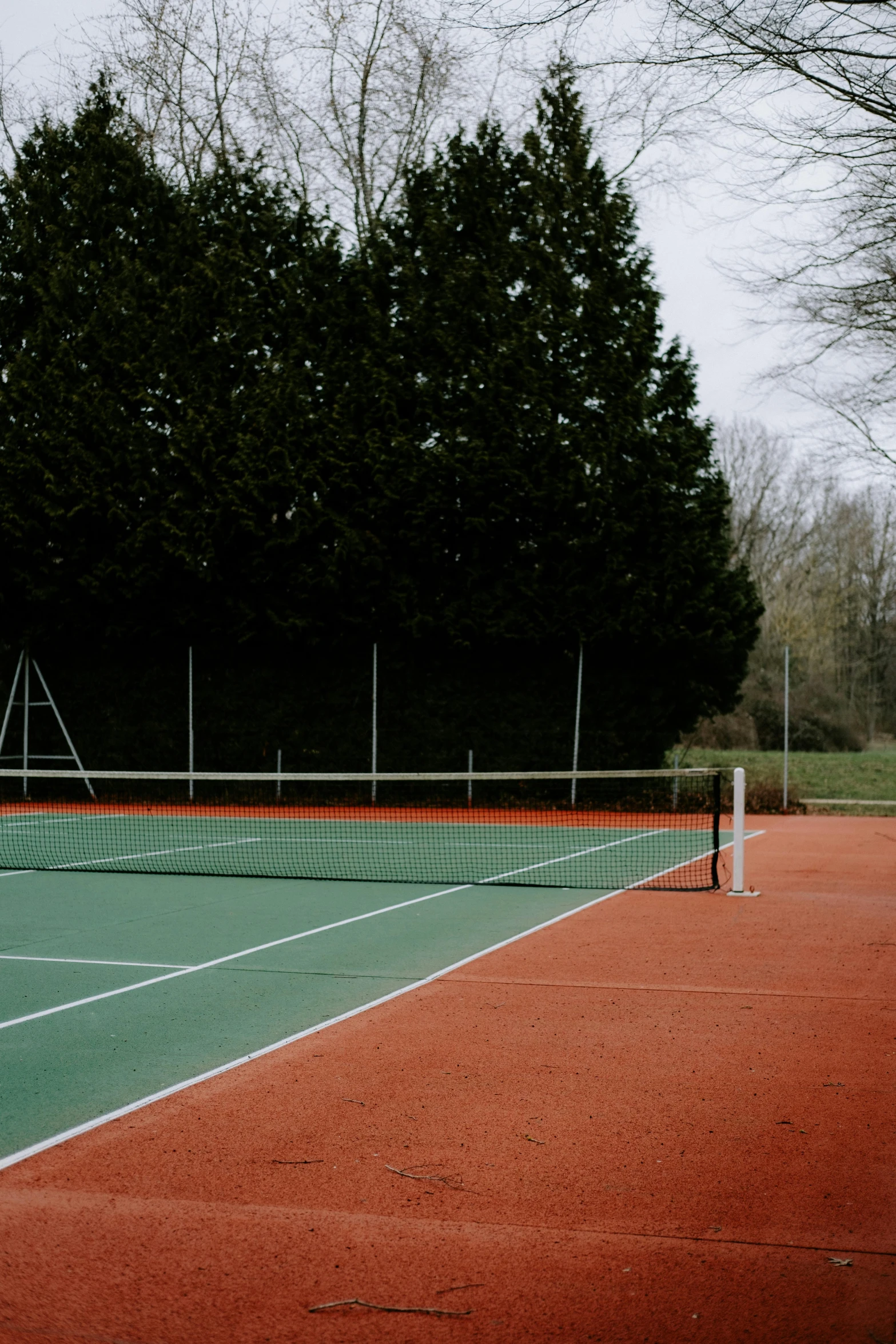 a tennis net sits on an outdoor court