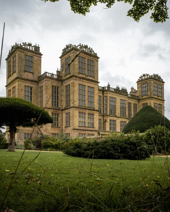 a huge building with two towers in the grass