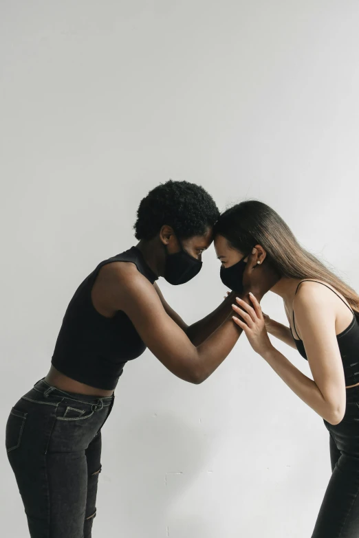 couple of a young man and woman who are touching their noses