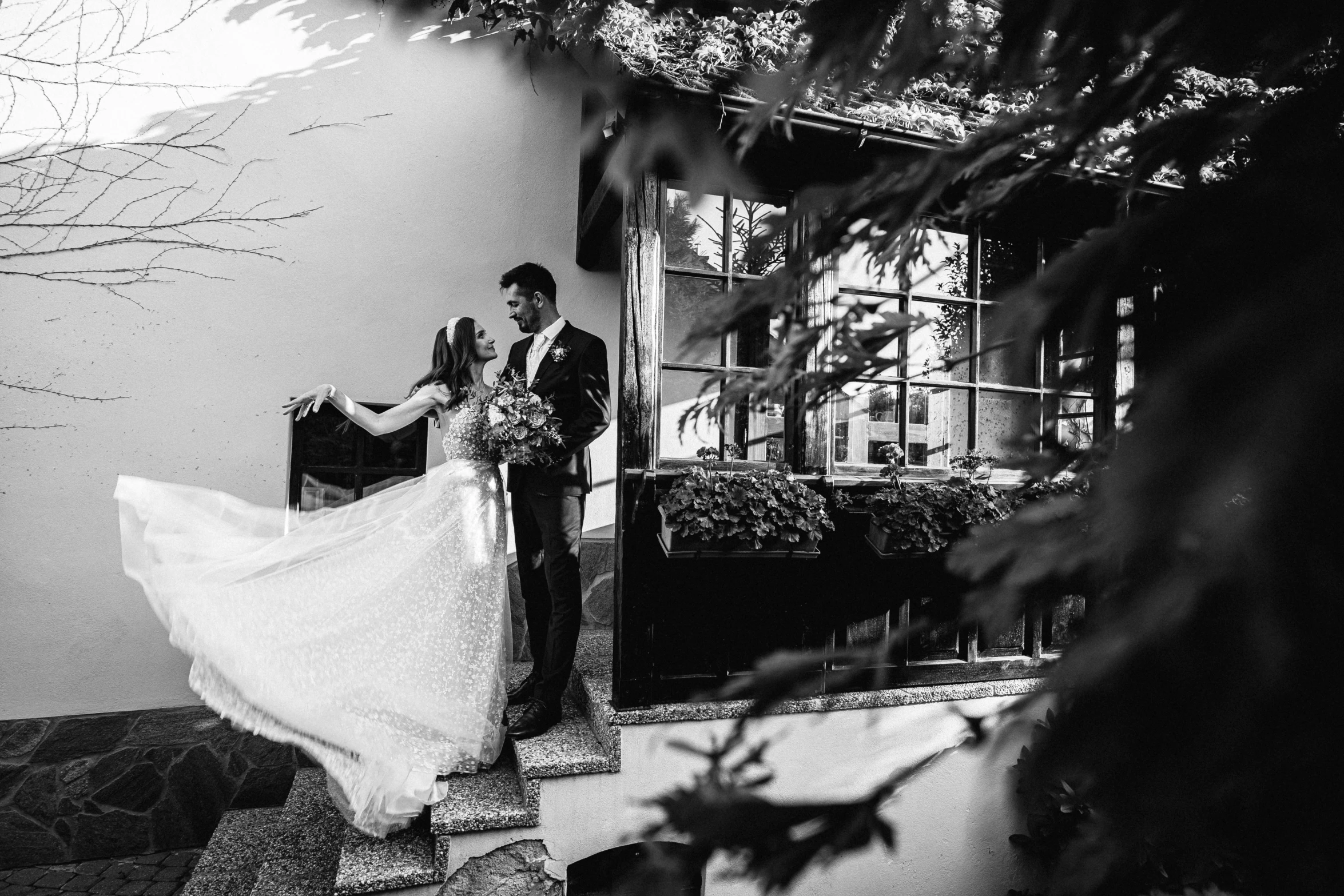 the bride and groom walk down the stairs of their wedding day