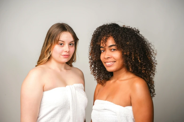 two women are standing side by side posing for the camera