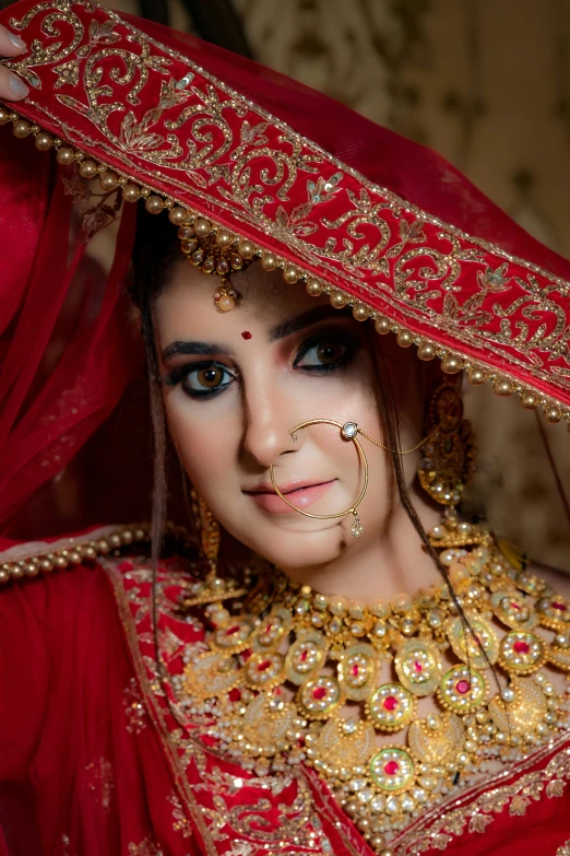 a bride wearing traditional jewelry posing for a portrait