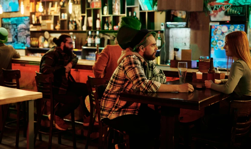 a man sitting in front of a bar counter