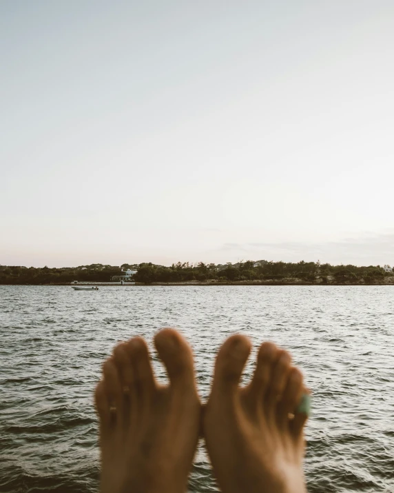 someone standing near water with their feet on the water