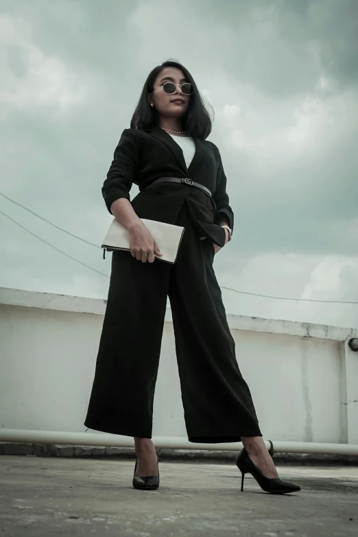 a woman is posing for the camera while wearing black shoes