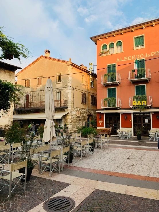 a restaurant with tables and chairs along side of a building