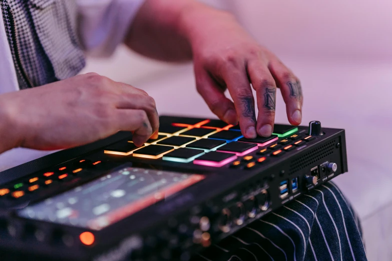 a person plays an electronic device with neon lights