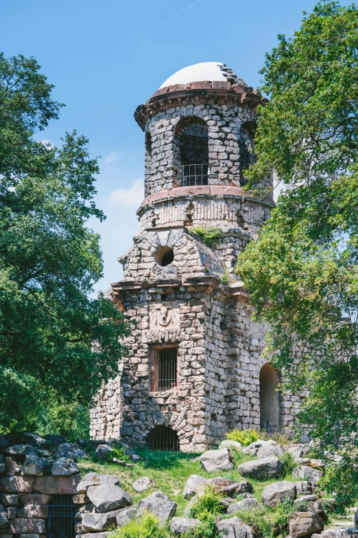 a stone tower sitting behind a bunch of trees