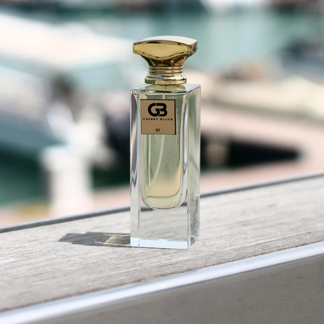 a small bottle of perfume sitting on top of a window