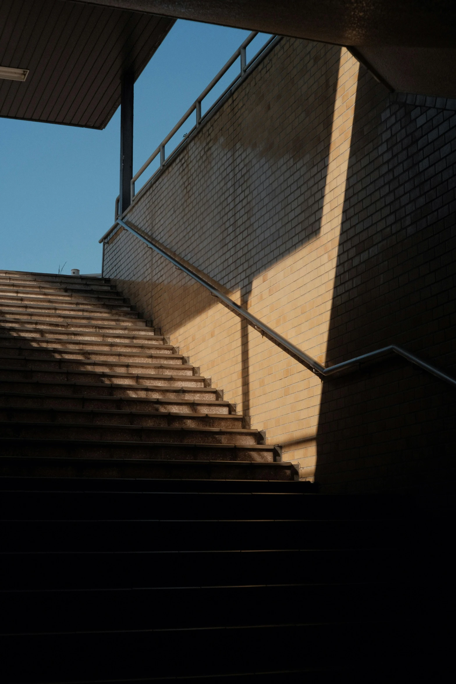 the stairs outside of a building with a person walking up them