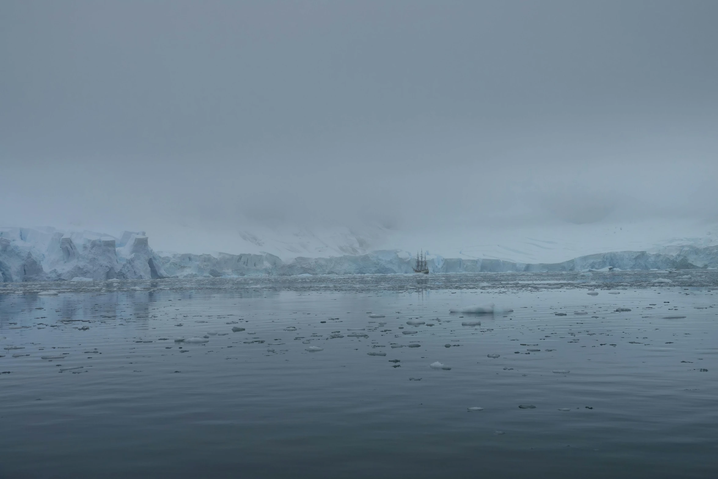 a body of water with ice floating in the air