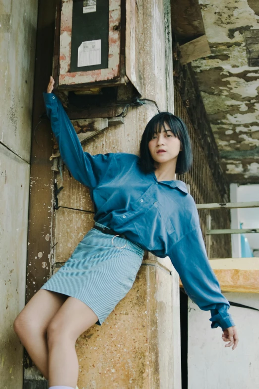 woman standing by a building in shorts and socks