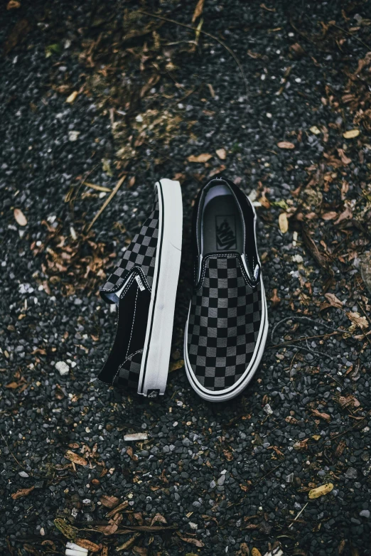 a couple of black and white shoes sitting on the ground