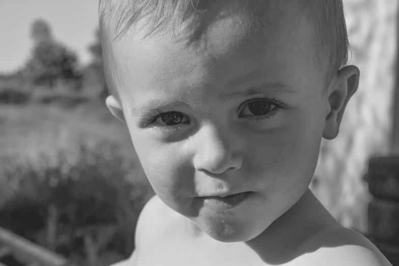 a little boy making a goofy face in the sun