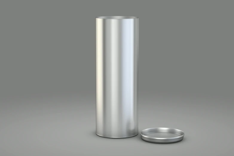 a large metallic pipe next to a small metal object