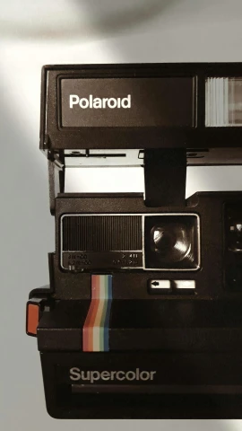 a polaroid camera with an expired striped roll