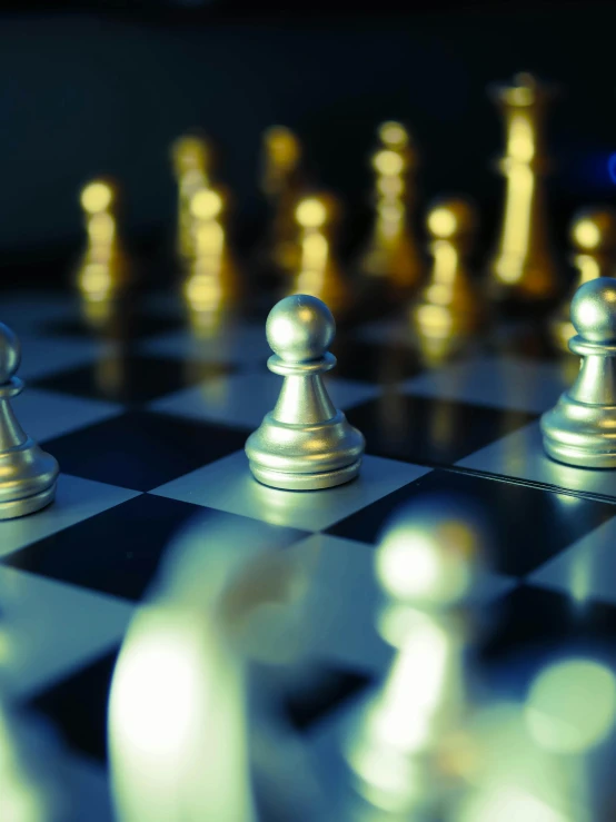 a close up view of a chess board with silver pieces on it