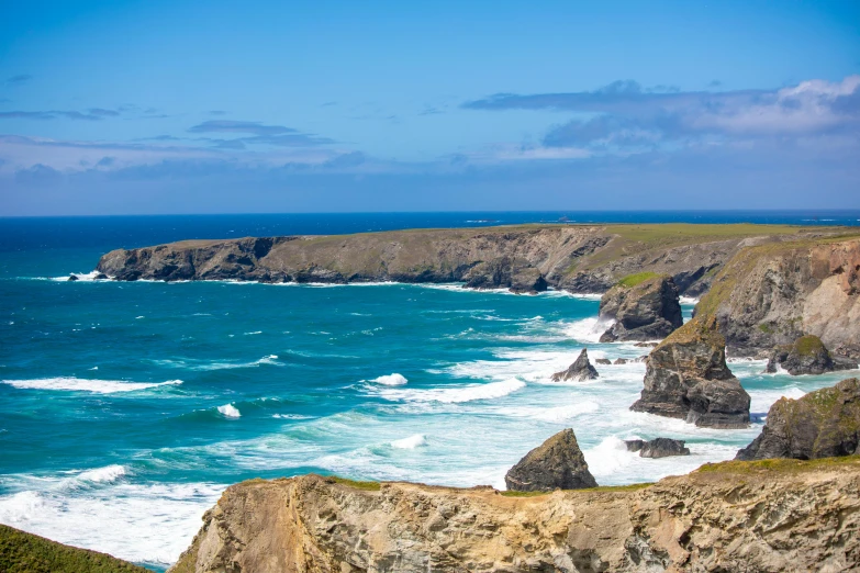 the shoreline is next to the rock formations