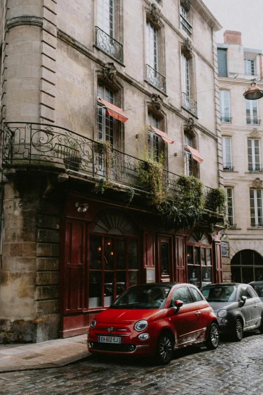 cars parked in front of a cafe in the rain