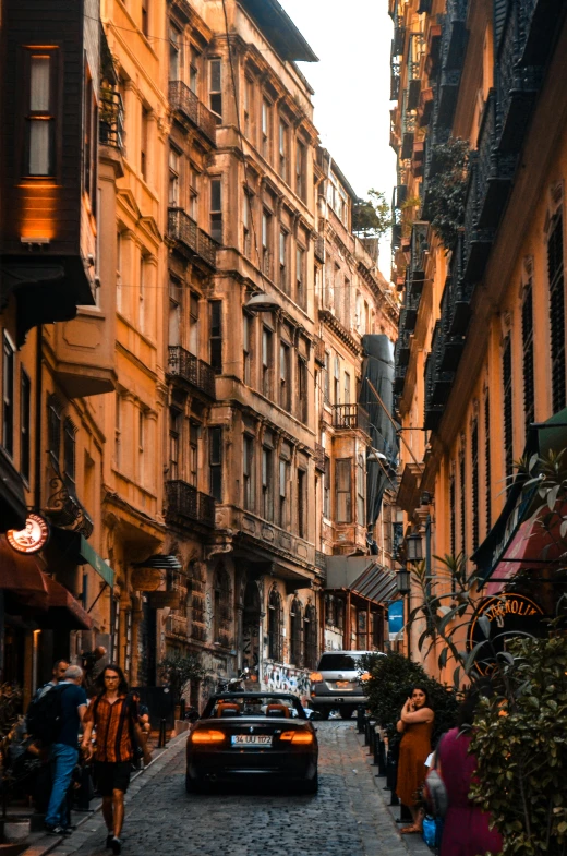 a city street with a car and parked cars on it