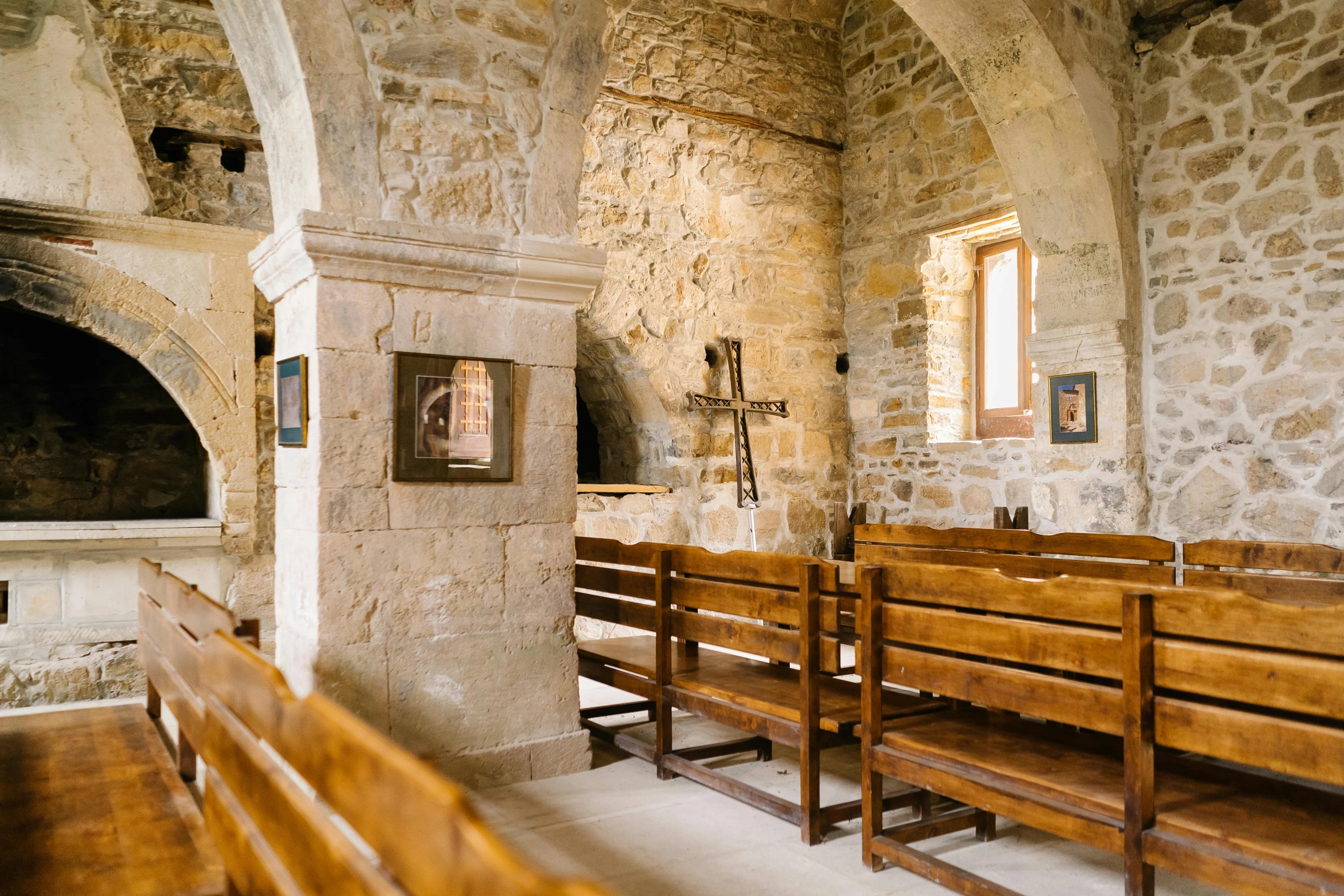 the interior of a church with wood benches