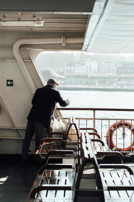 a man standing at the helm of a ship