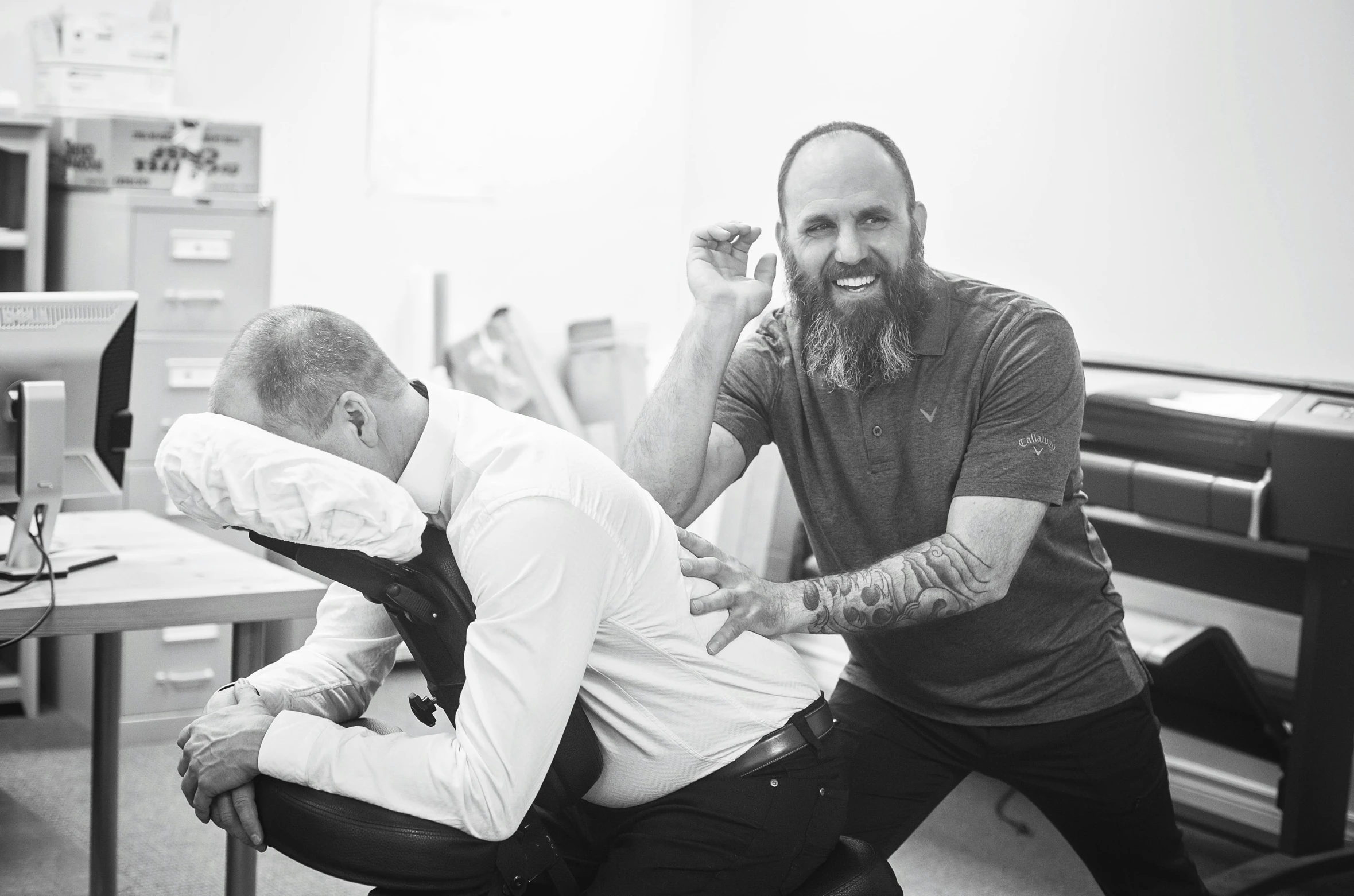 man holding another man's neck while they both hold hands and smile at one another