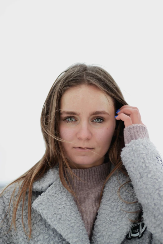 a woman holding her cell phone to her ear while posing