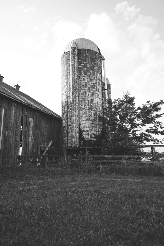 a small silo is sitting in a field