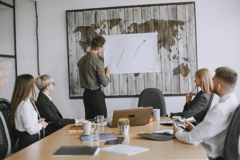 a group of people sit around a conference table