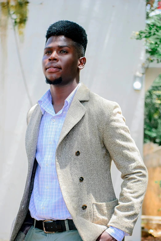 young african man in dress shirt and blazer looking at the camera