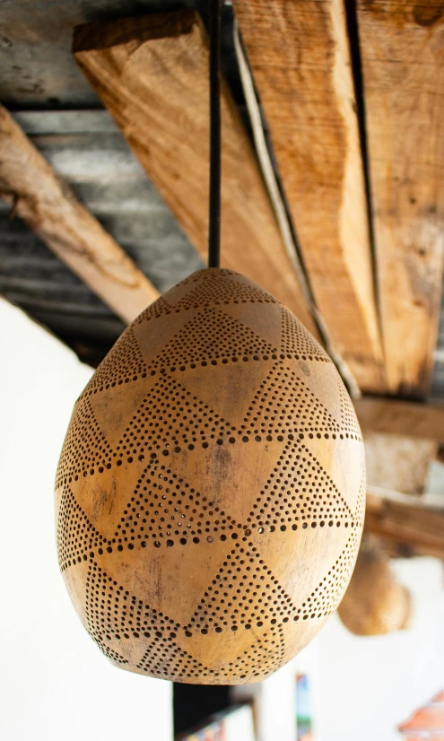 the decorative wooden hanging light fixture is made from wood