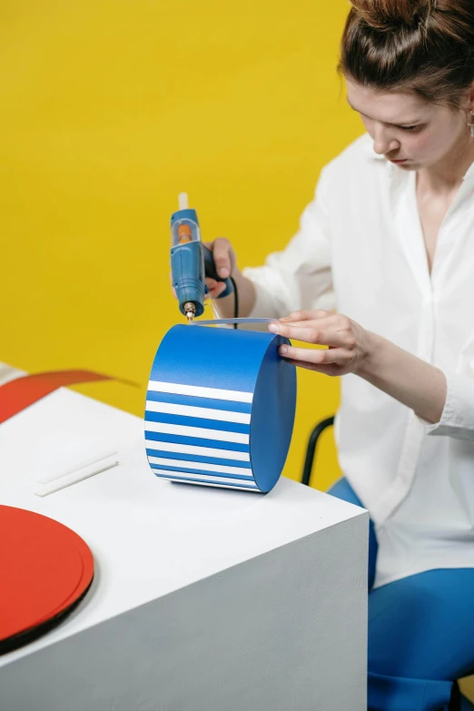 the woman is using an electrical tool to repair a box