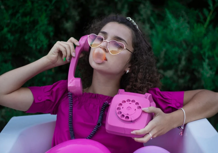 an african american woman wearing pink talking on the phone