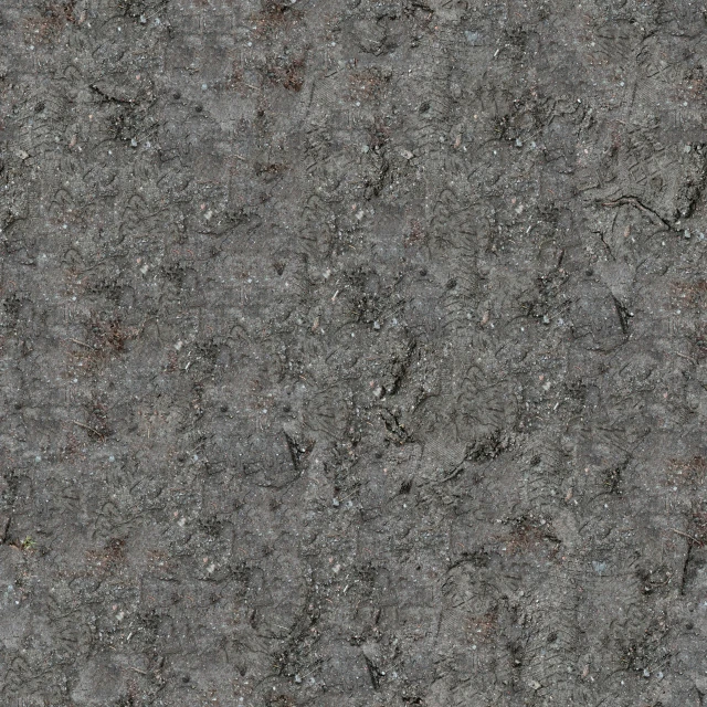 a grey wall with spots of dark colored stuff on it