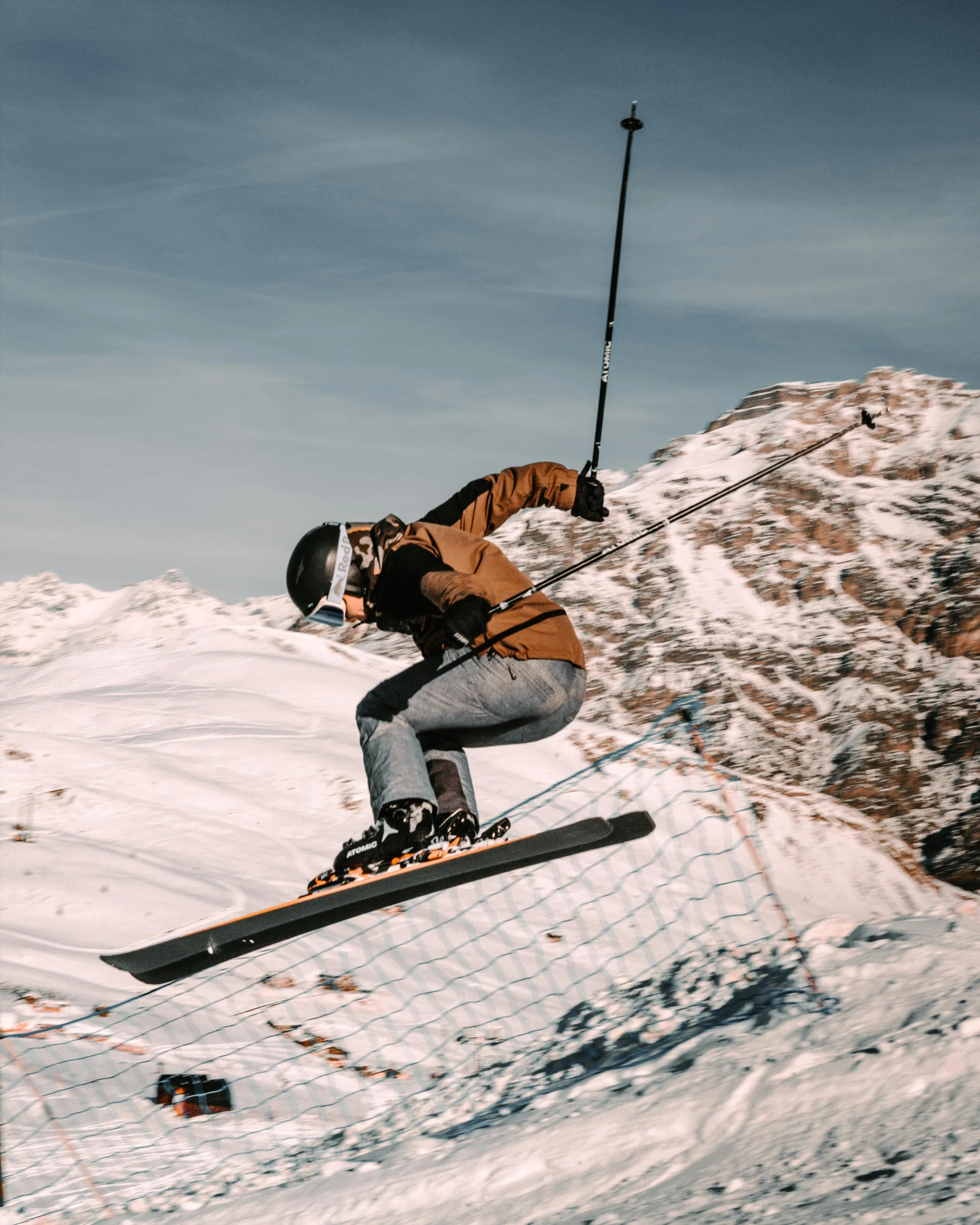 a person is snowboarding on a high slope