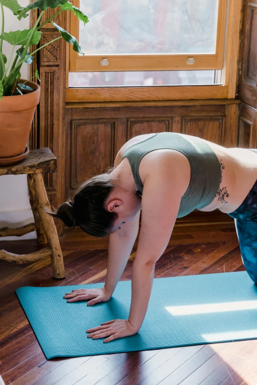 a woman is doing yoga poses in front of a window