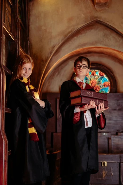 two people wearing harry potter outfits holding books