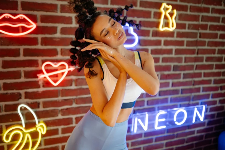 woman posing in front of neon signs